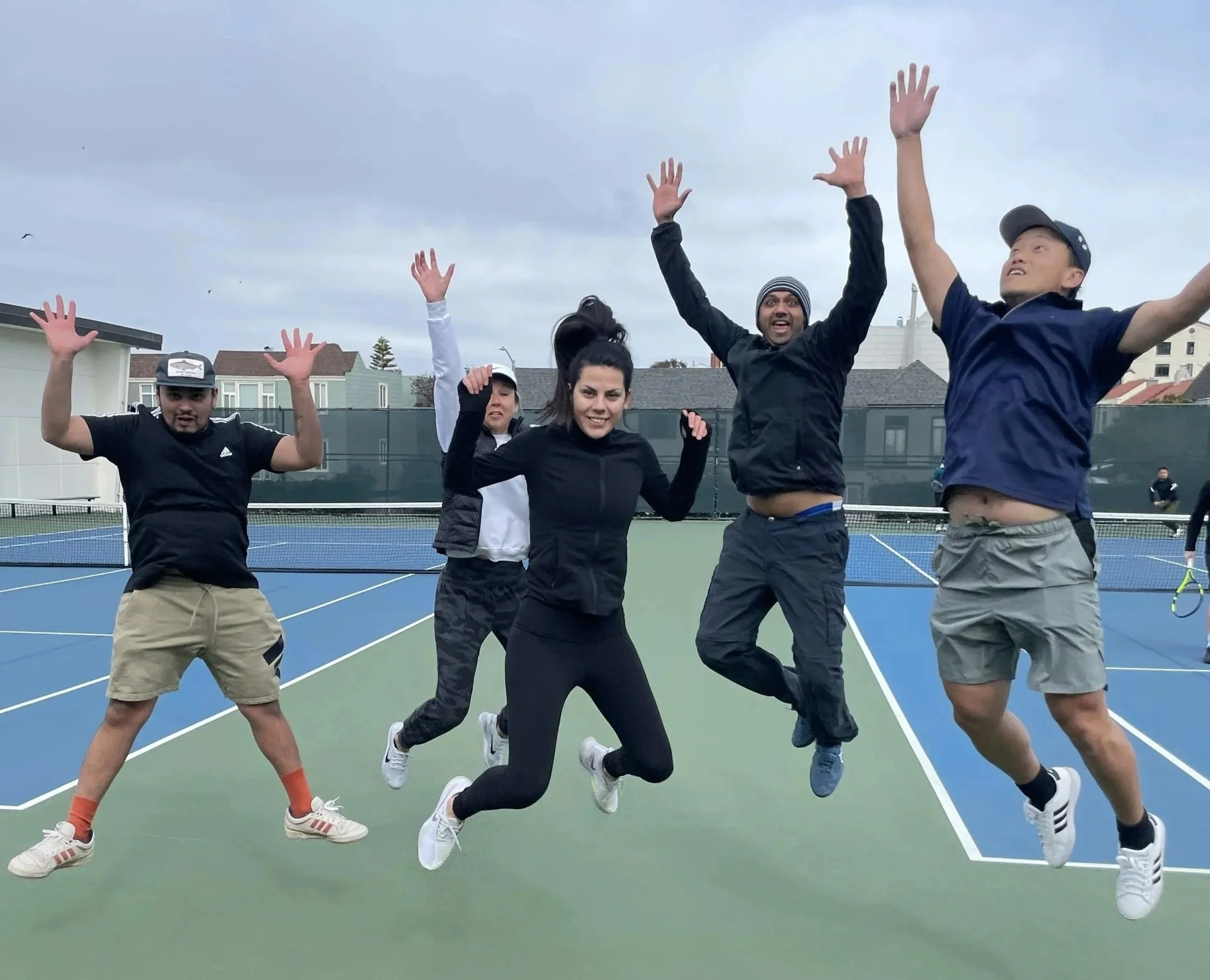 Rossi Racquet Club members giving the highest of fives at Rossi Park courts
