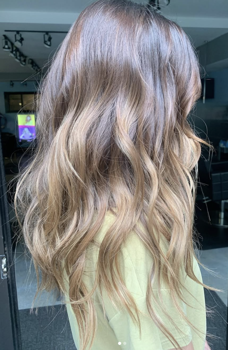 Woman with long, wavy, blonde hair.