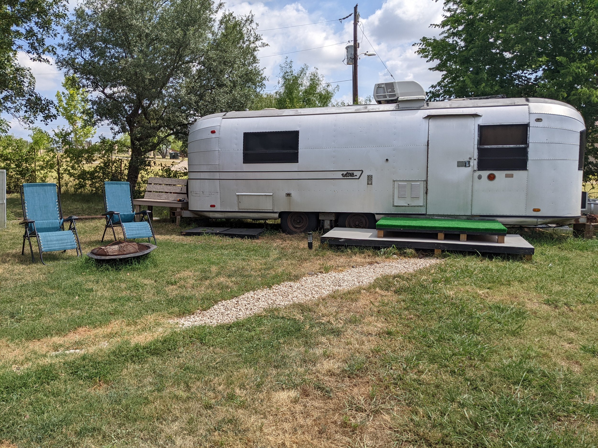Blue Note Airstream exterior with chairs and firepit