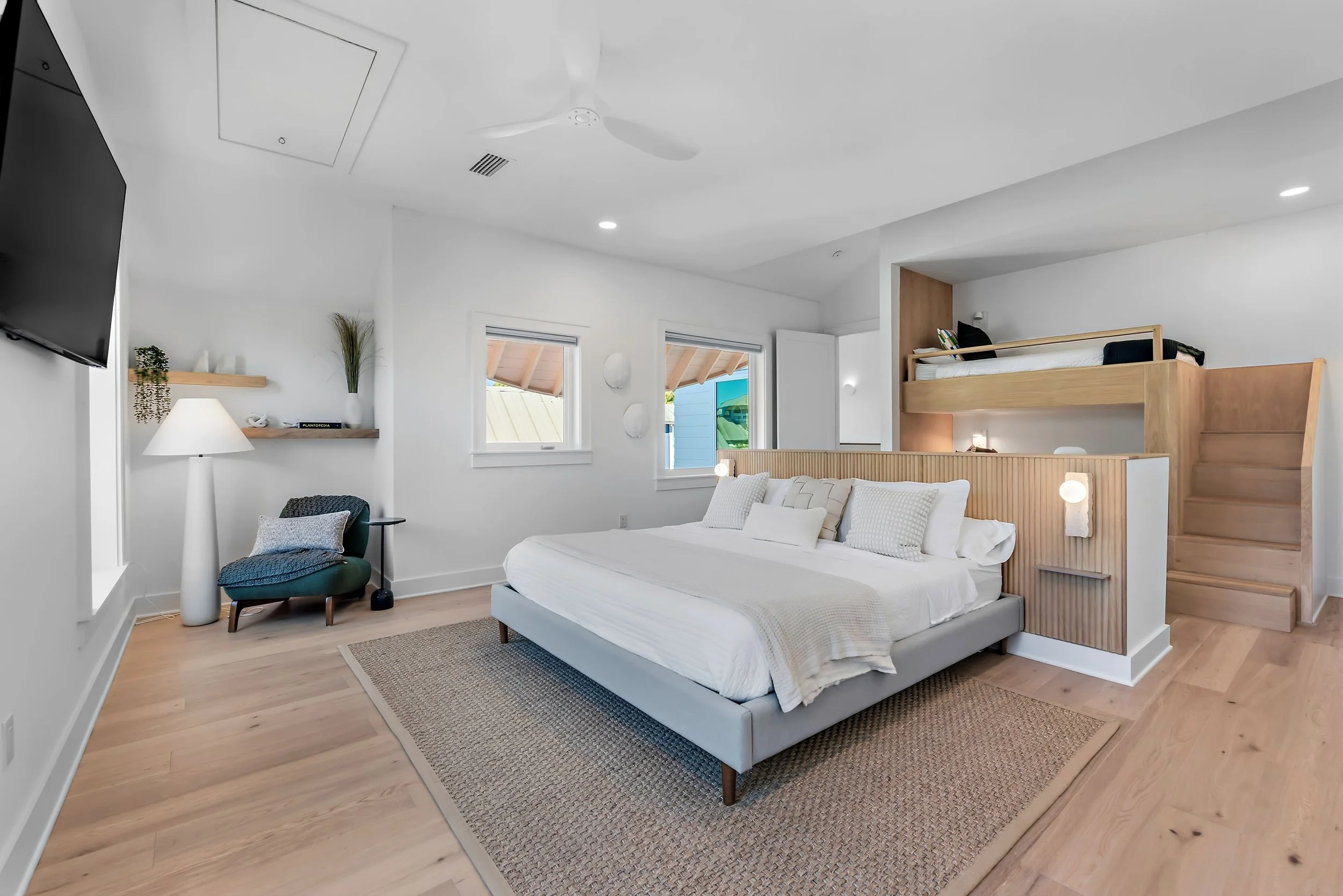 Flexible family room with a queen bed, custom XL bunk bed, and dedicated workspace—perfect for families or remote work stays.