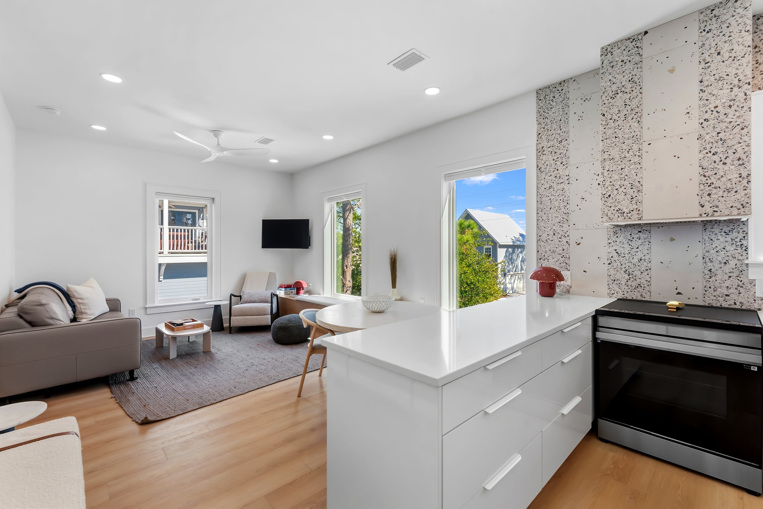 Open-concept guest house kitchen and living area designed for relaxed coastal living along Florida’s Scenic Highway 30A.