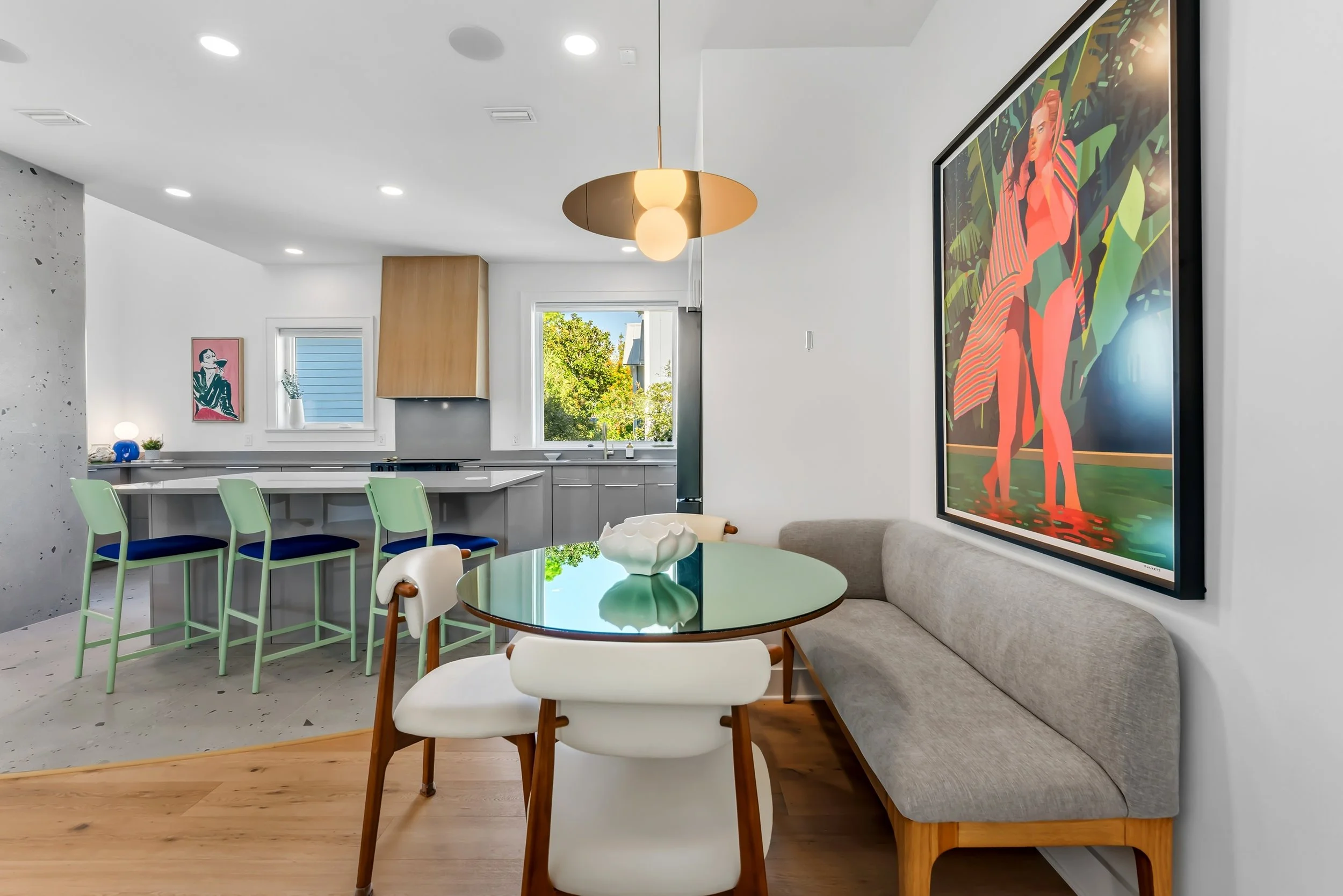 Sun-filled primary suite with a king bed, thoughtful interior design, and vibrant blue accents, complete with a smart TV and a private ensuite bathroom.