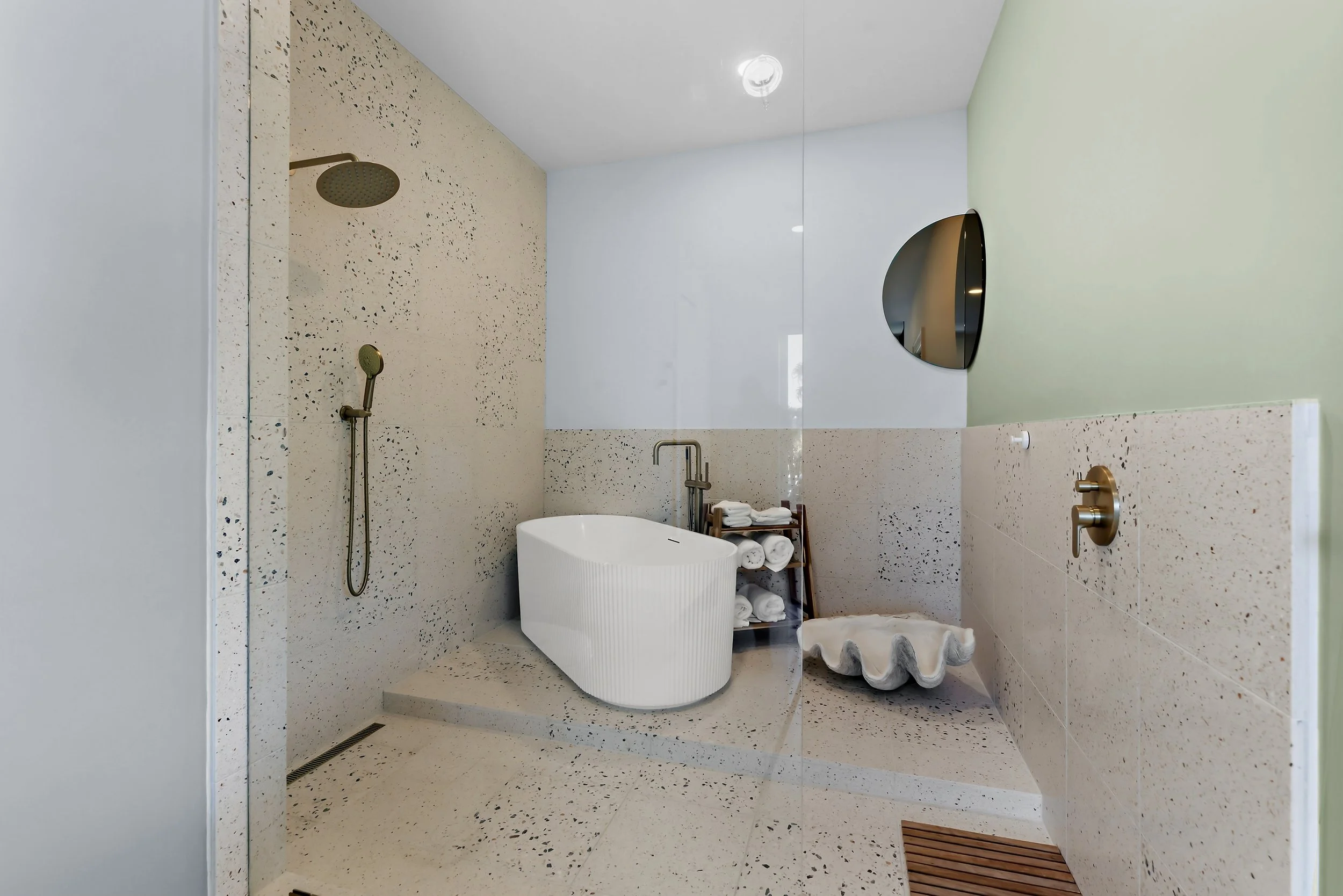 Modern main house bathroom with walk-in shower, custom vanity, and thoughtfully selected finishes.
