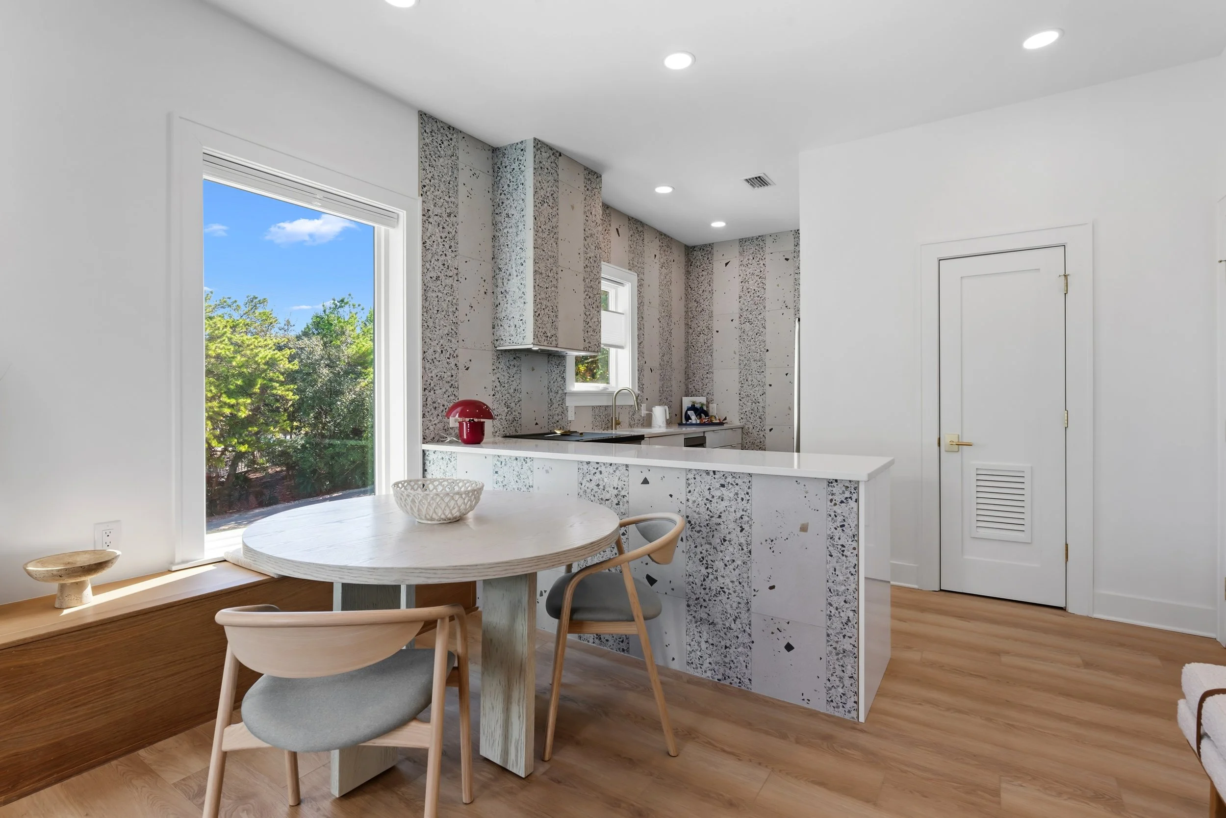 Open-concept guest house kitchen and living area designed for relaxed coastal living along Florida’s Scenic Highway 30A.