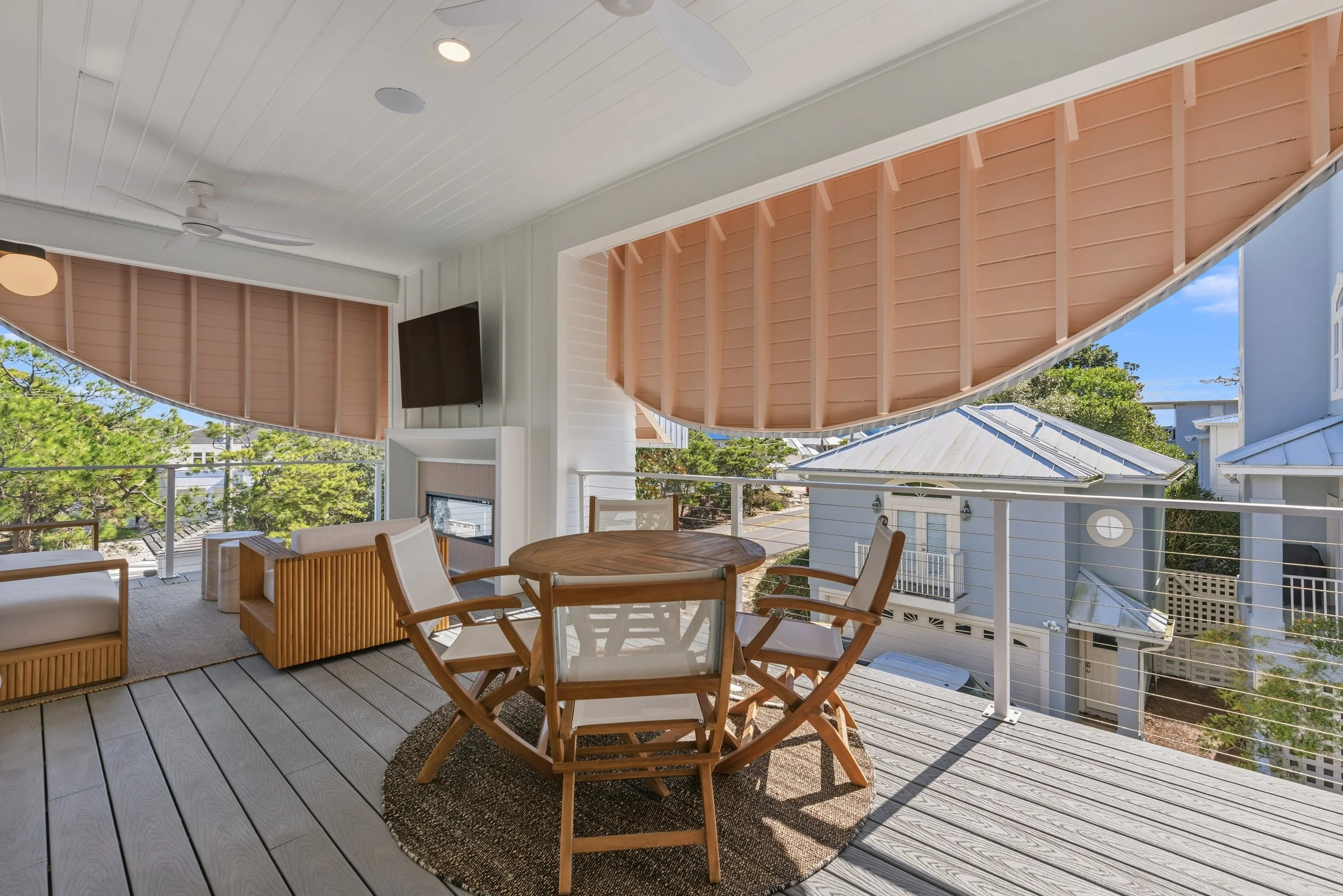 Expansive private porch offering shaded outdoor living and neighborhood views near the beach.