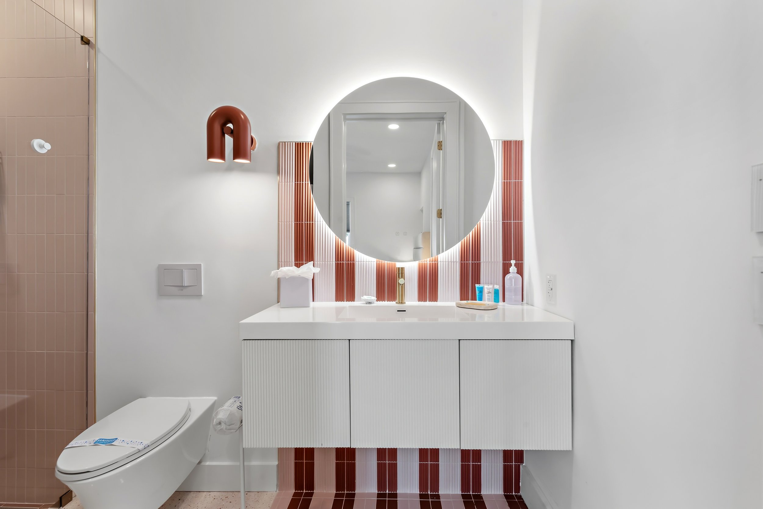Modern guest bathroom with a spacious walk-in shower, custom vanity, and refined coastal finishes.