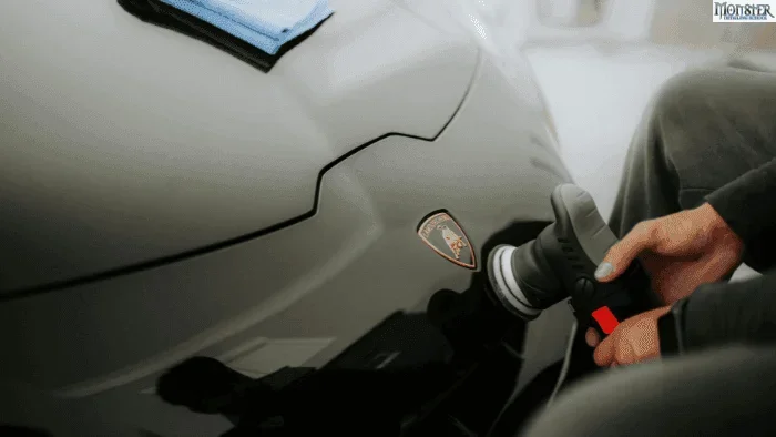 Detailing technician performing final paint inspection on a luxury vehicle. Ensuring flawless finish before ceramic coating delivery in North Alabama