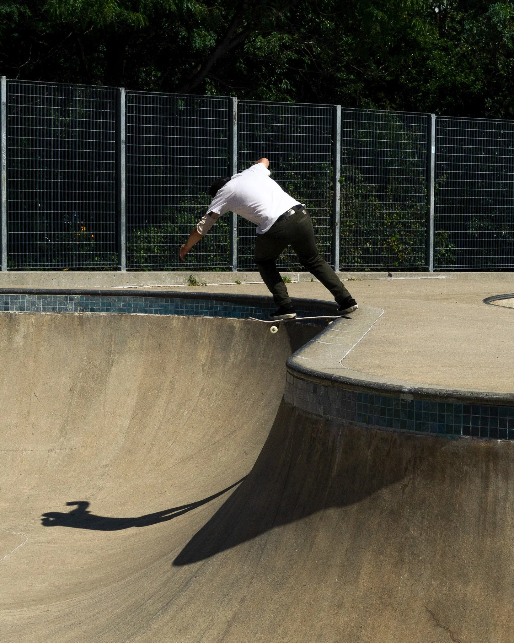 Person skateboarding in a concrete skatepark.