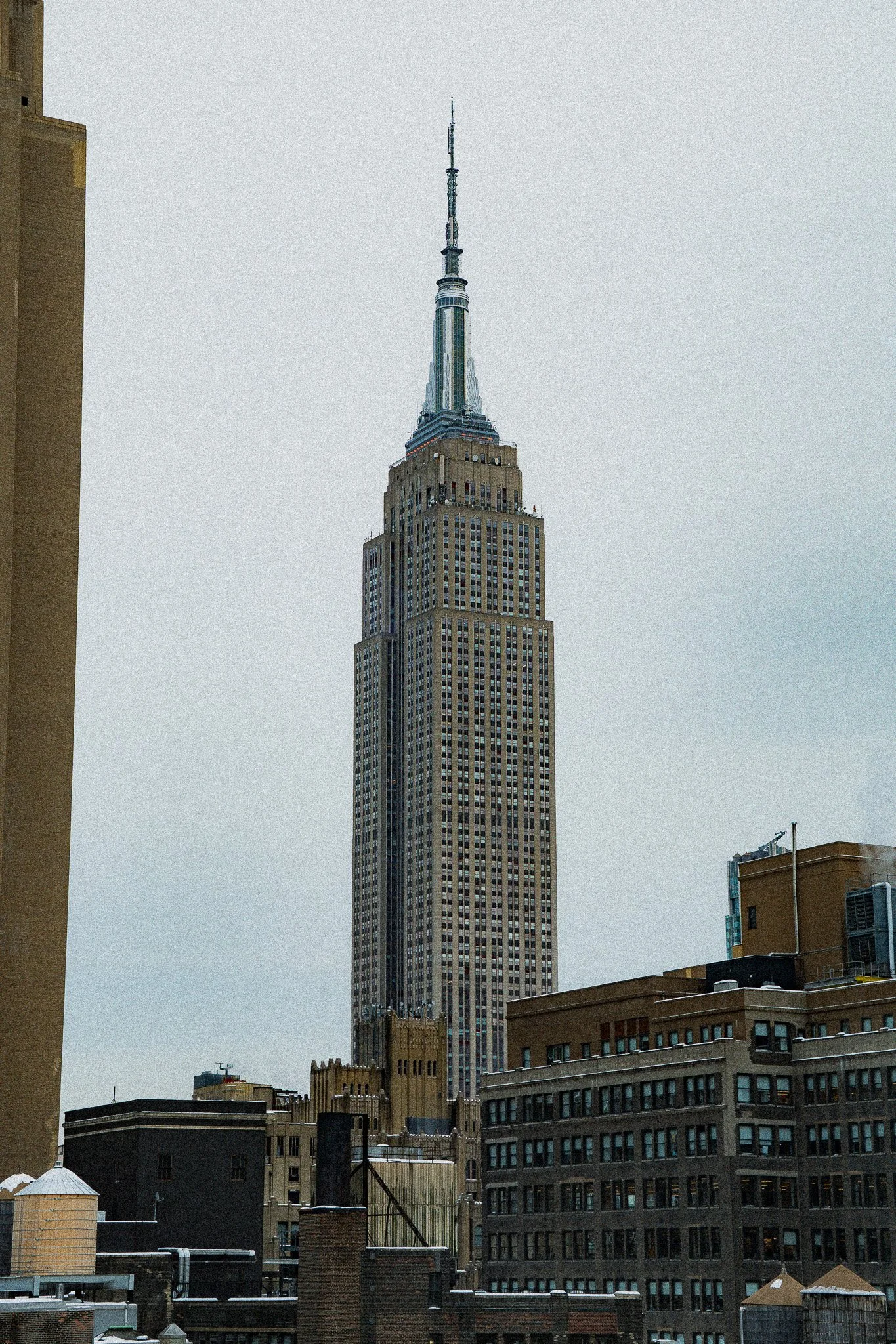 View of the Empire State Building in New York City during cloudy weather.