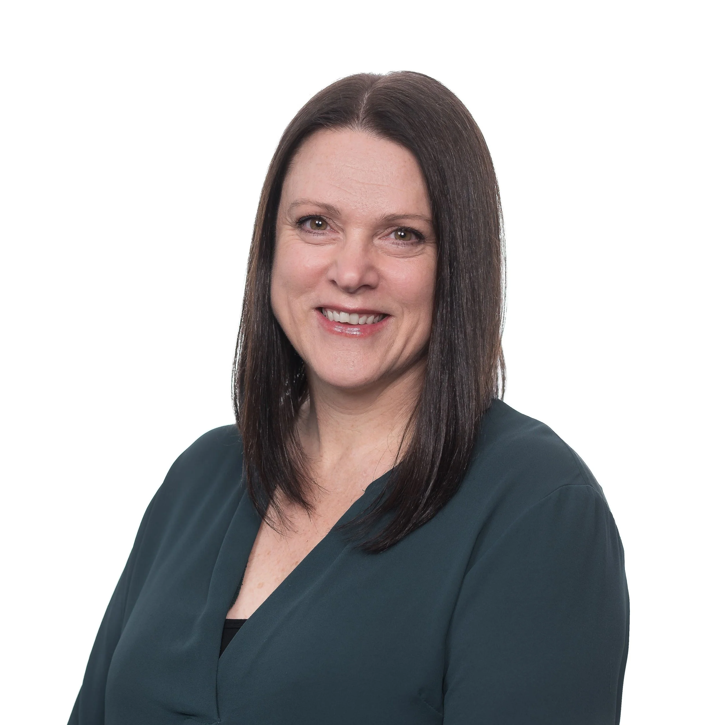 Professional portrait of a woman with long dark brown hair, smiling, wearing a dark teal blouse, against a white background.
