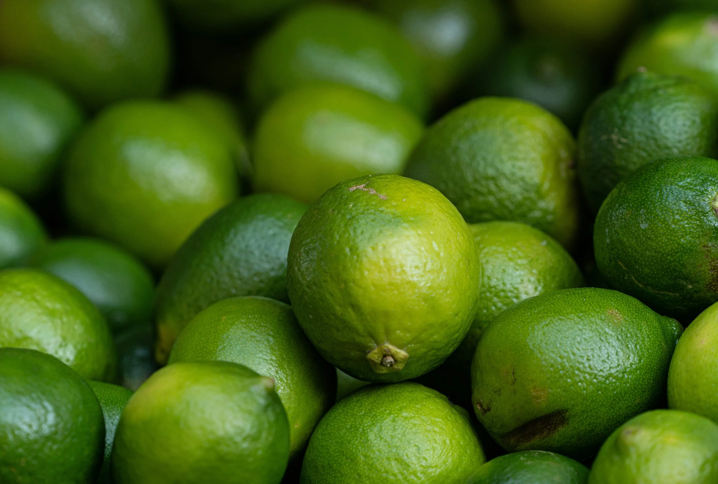 A pile of fresh, green limes.