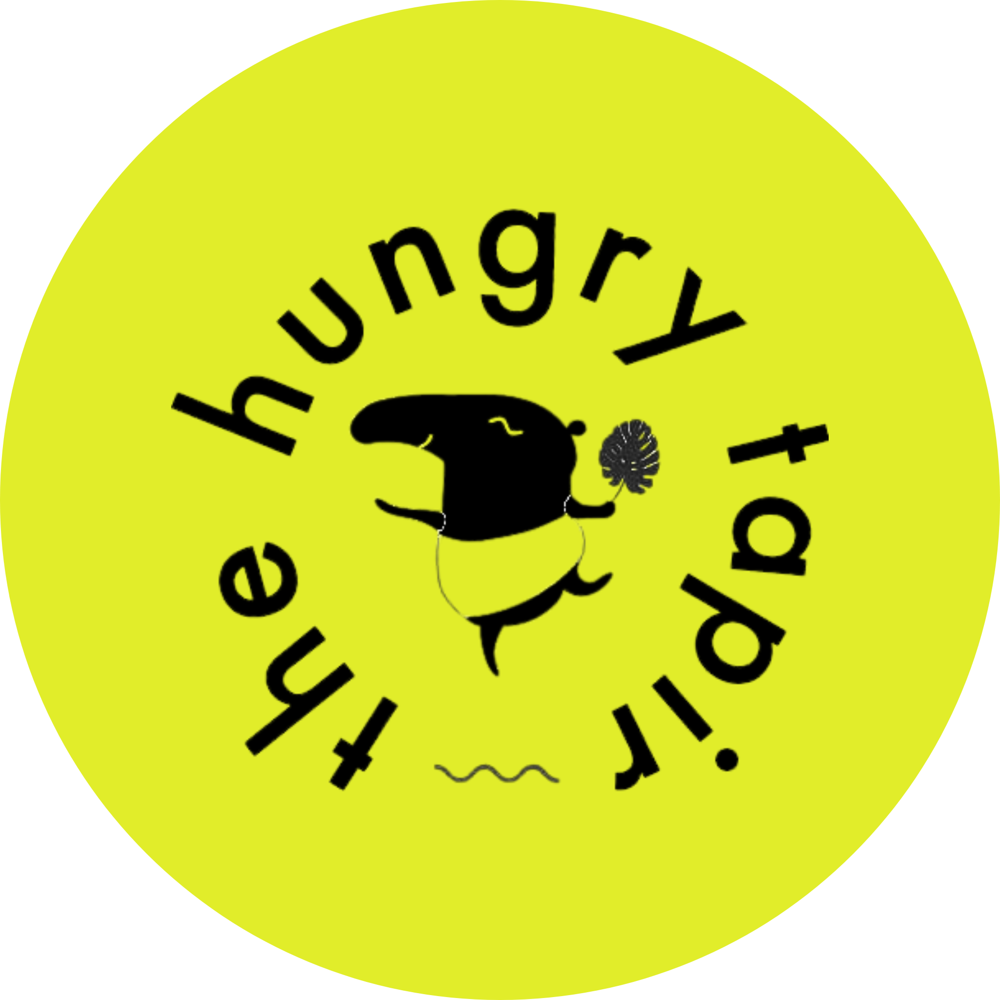 A bright yellow circular sticker with the text 'the hungry + tired' written in black around the circle. In the center, there is a cartoon illustration of a mouse holding a leaf, with a wavy line indicating tiredness or sleep underneath.