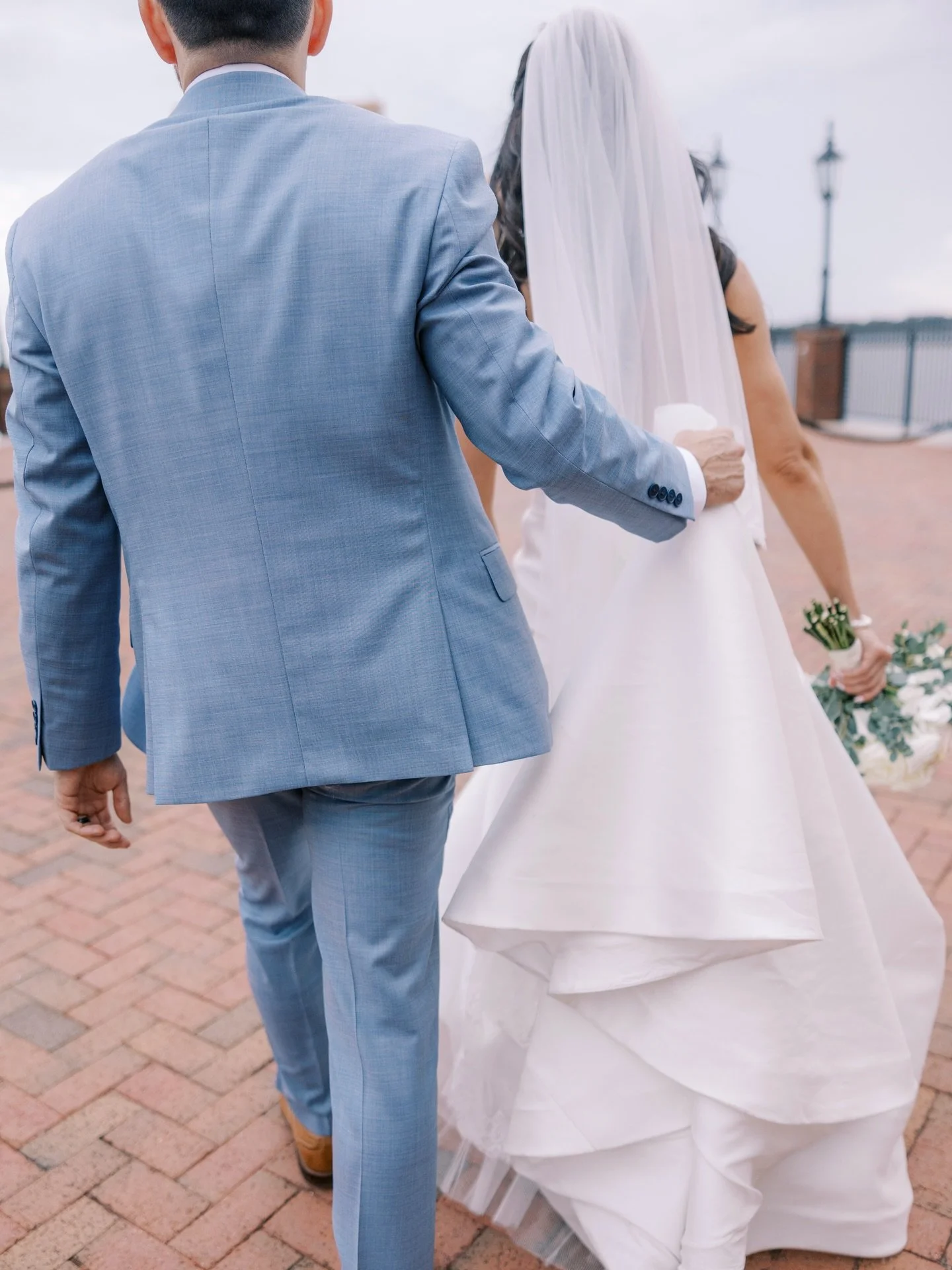 I love documenting the in-between moments like when he quietly gathers her train as they walk to their celebration after portraits. 🤍

Behind the scenes has been VERY full lately. Two wedding galleries delivered already this week and so much happeni