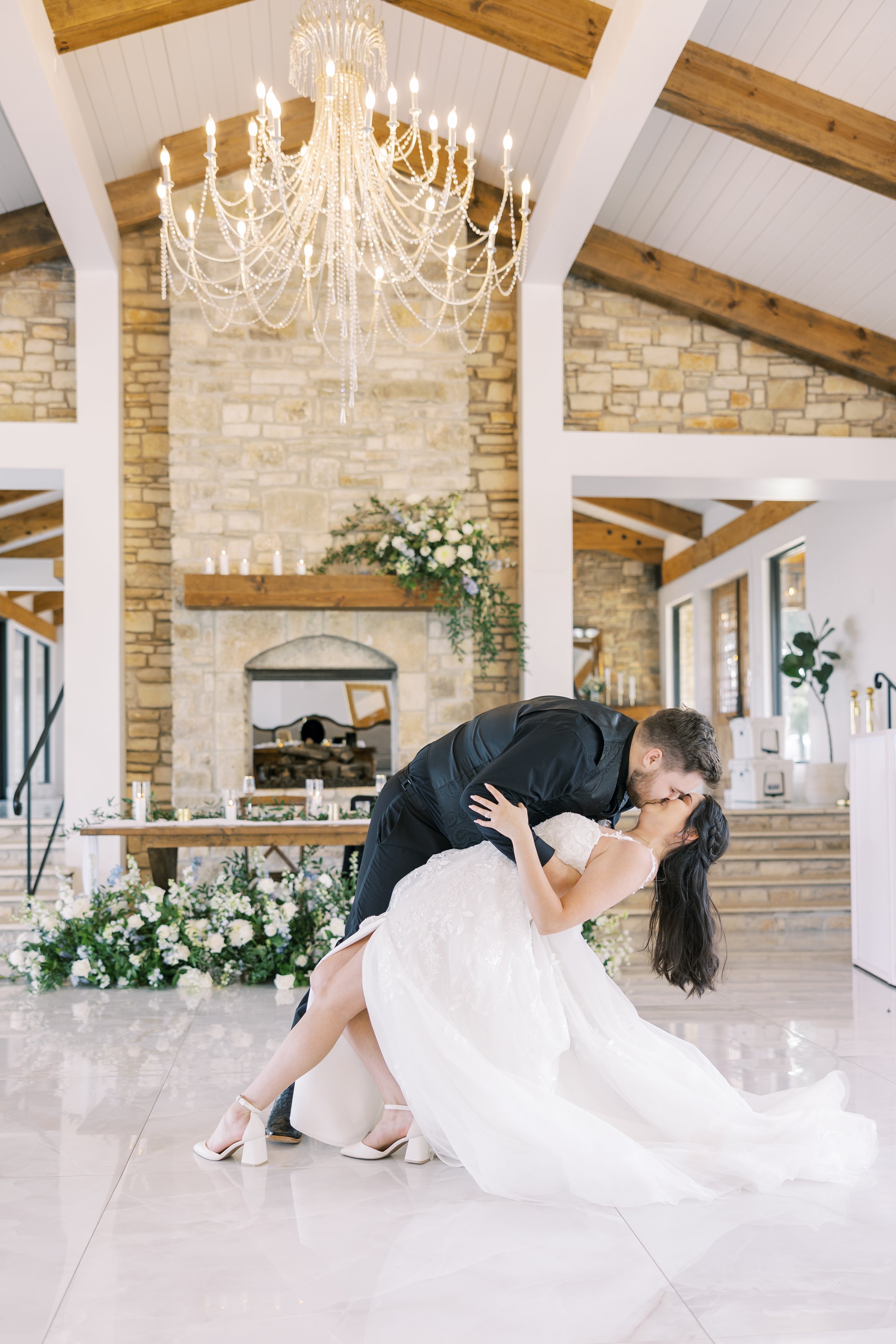 A bride and groom share a dip kiss after their first dance at an Orlando wedding reception