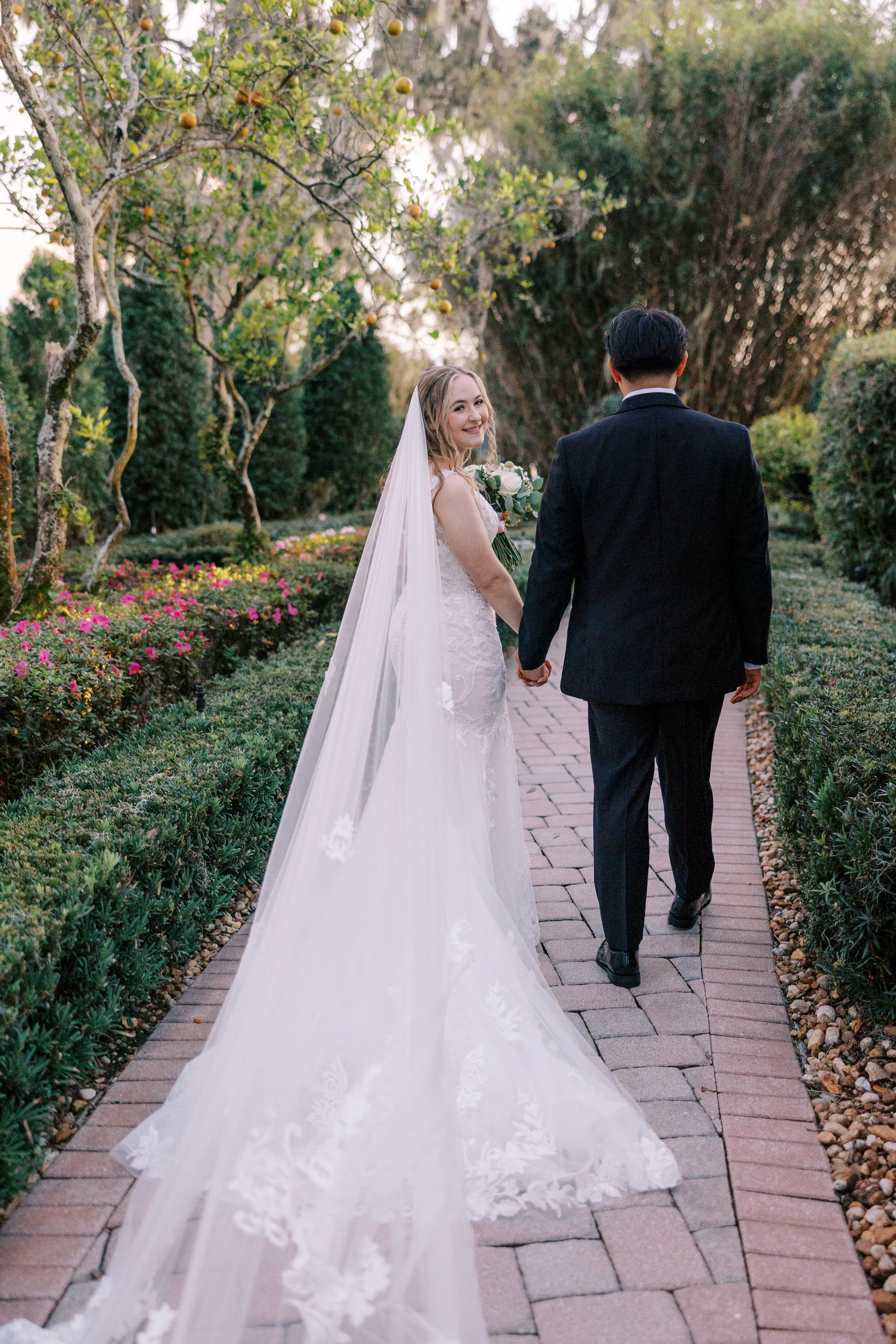 Bride and groom holding hands at their Central Florida wedding, photographed in true color