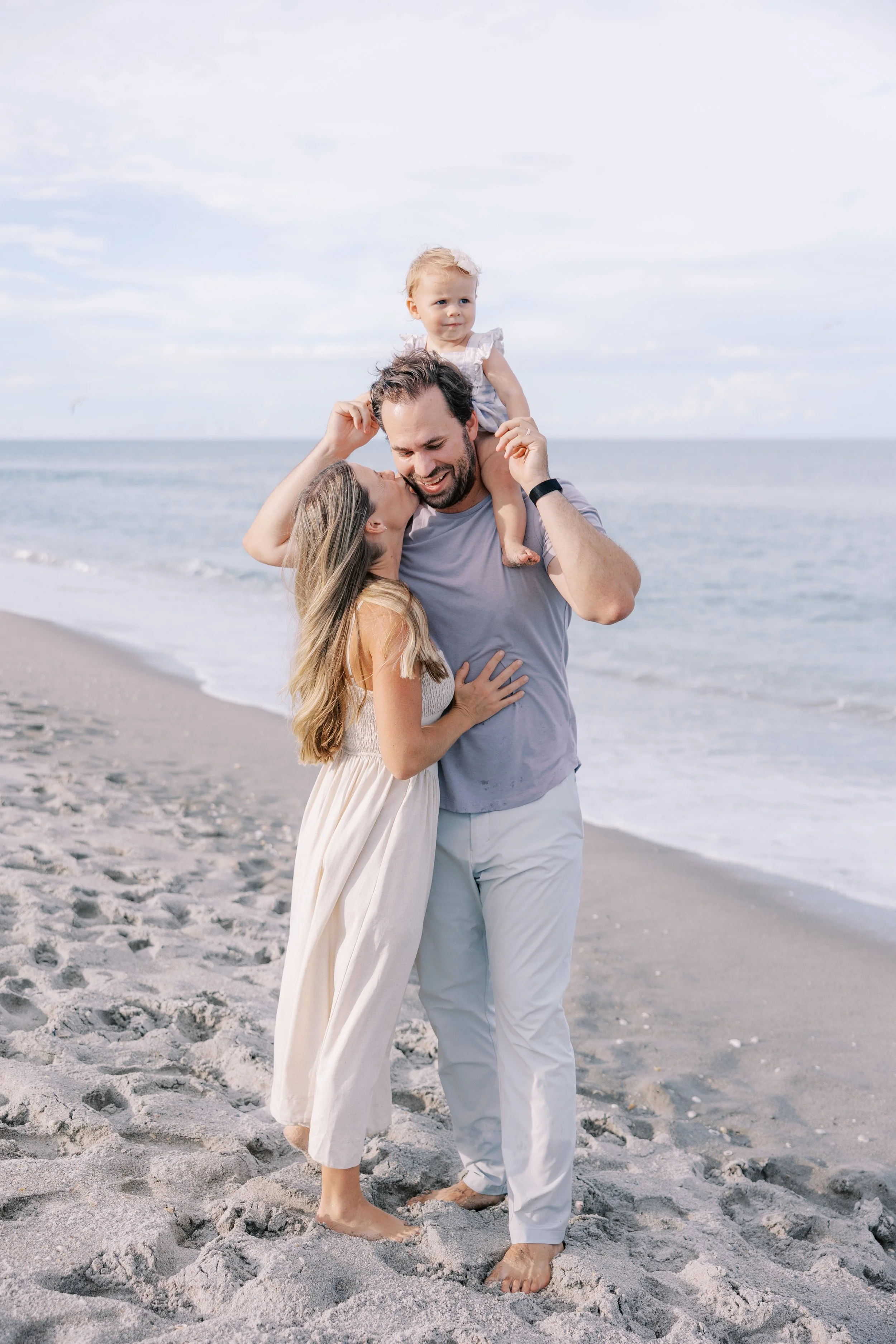 Young family candid moments together on the beach in Melbourne Florida captured by Central Florida family photographer