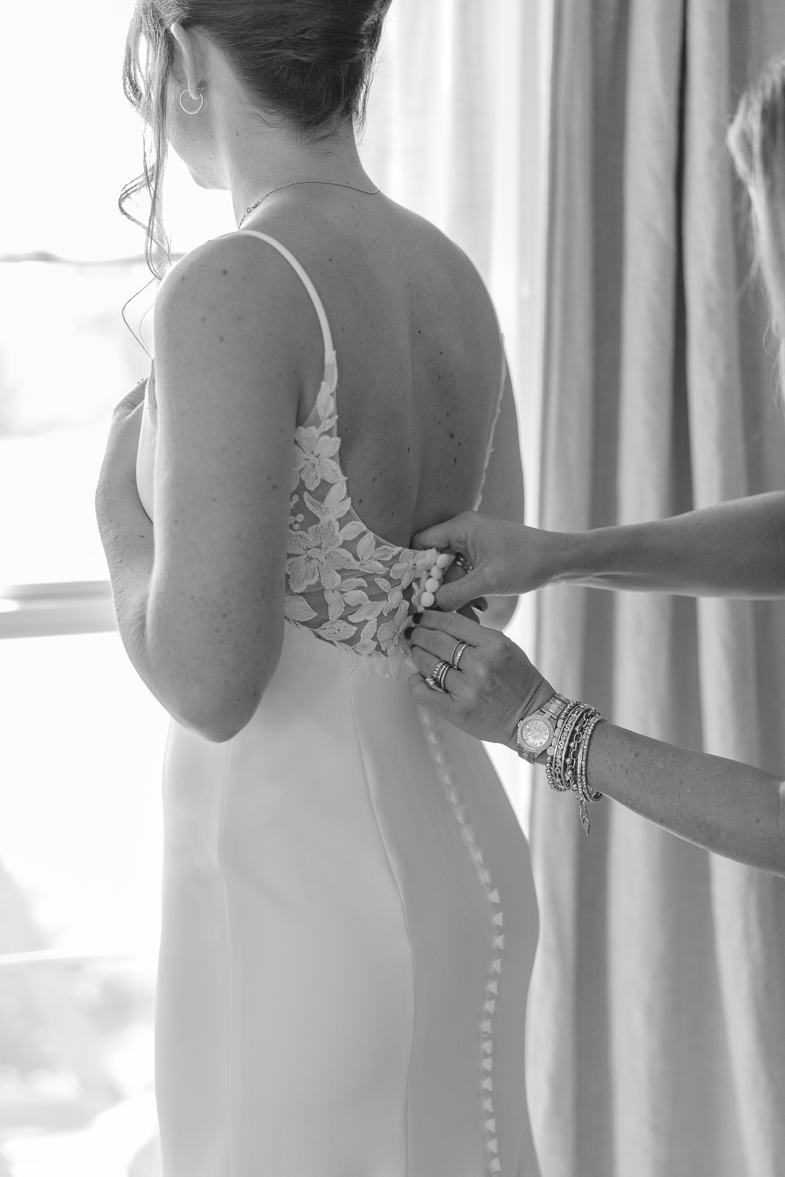 Close up of bride's gown being fastened before walking down the aisle on her Central Florida Wedding day