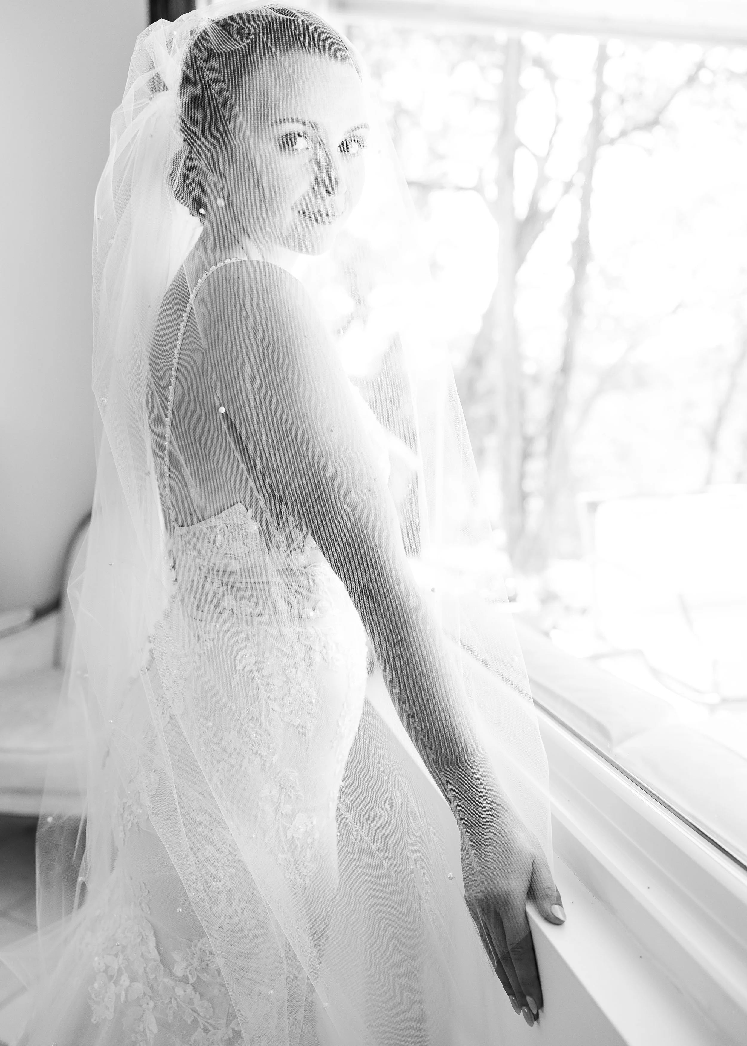 Orlando Wedding Photographer Capturing a Bride's Quiet Moment Looking Through Her Veil Photographed in Natural Light with True Color Editing