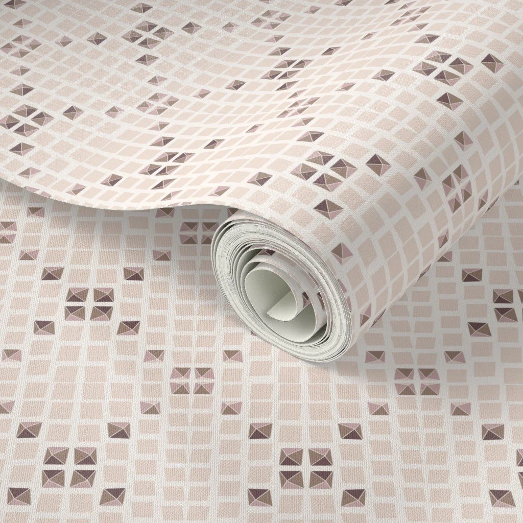 An example of a spoon flower design from Pratyasha Sharma ( Align One Surface Patern Studio) is depicted on a product: a roll of wallpaper unrolled to show a geometric pattern of uneven squares and triangles in shades of beige, pink, and brown.