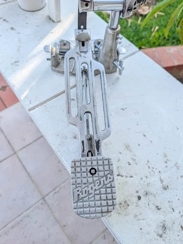 top down view of drum pedal on white shelf