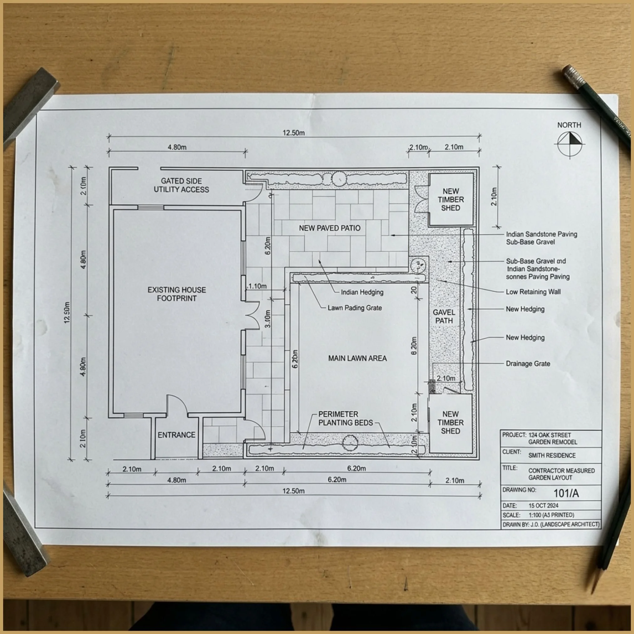 Overhead view of an A3 printed garden layout sheet. The contractor-facing page shows dimensional references and precise hardscape geometry.