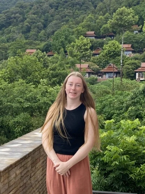 A young woman with long hair looking at the camera. 