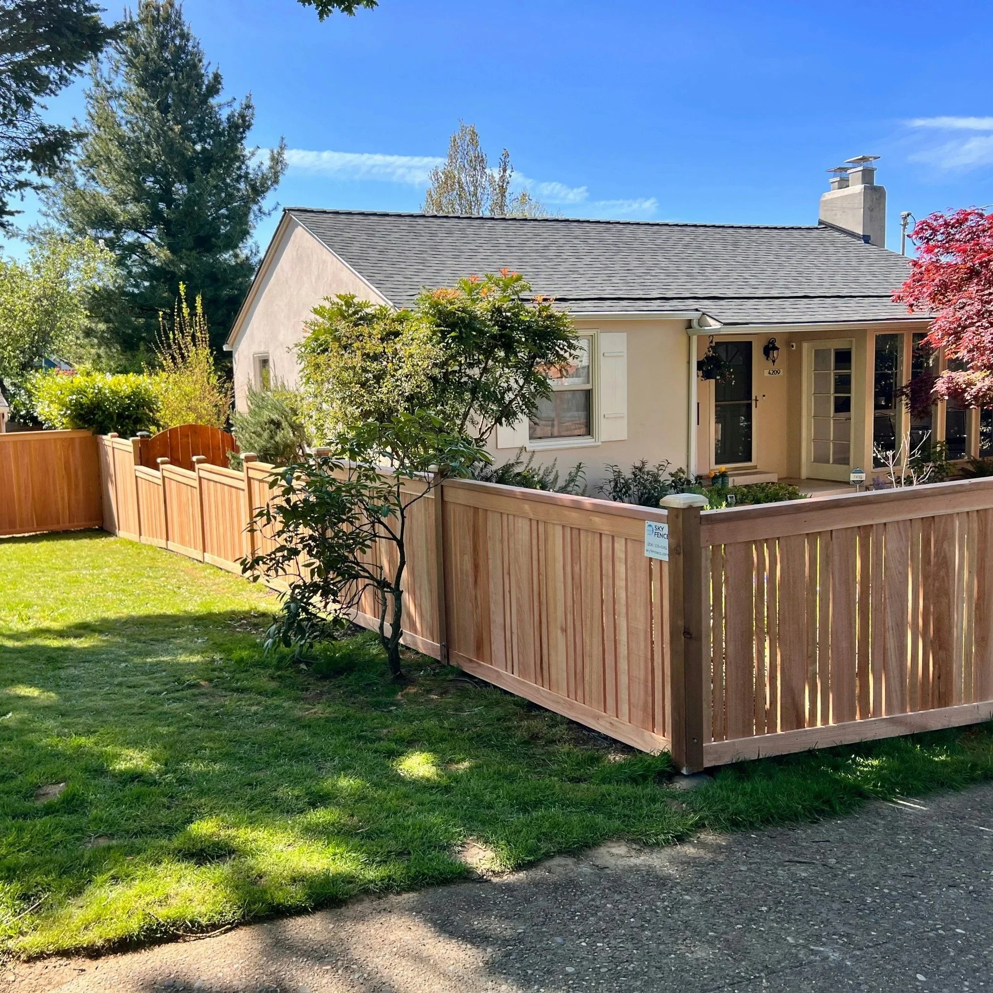 New backyard wood fence illustrating cedar and pressure-treated pine fencing materials designed for durability in humid North Carolina weather.