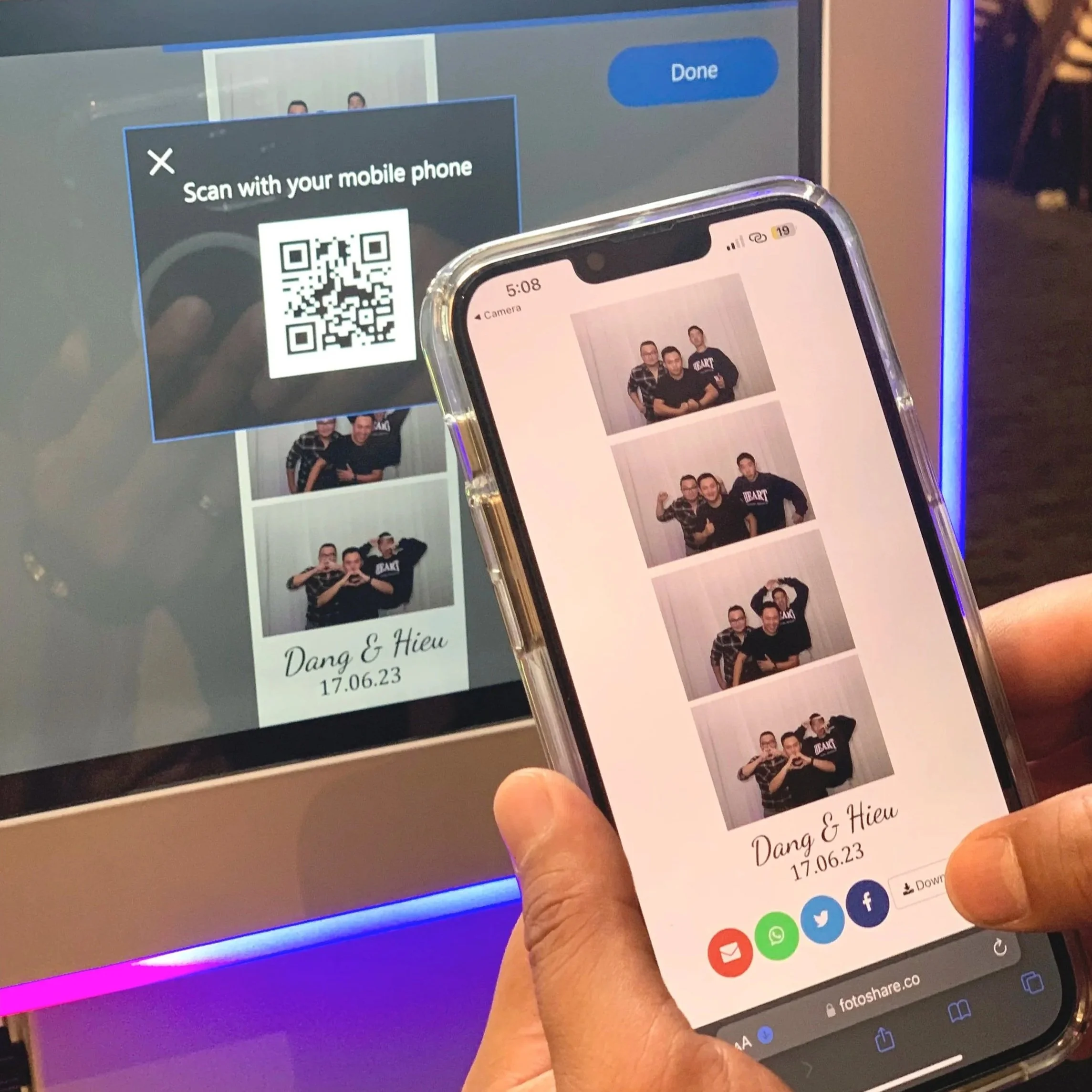 A person's hand holding a smartphone displaying photo booth pictures of three men making various gestures, with drawing icons below, and a screen showing a QR code and photo information for Dang & Hieu, dated 17.06.23.