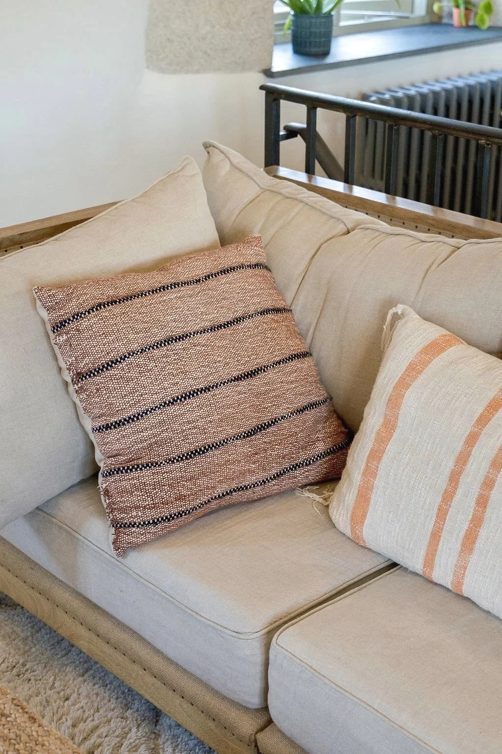 Natural living room styling with striped cushions and soft seating at Stargazey.