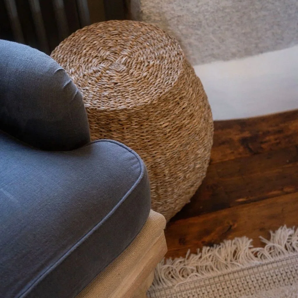 Woven basket and linen chair on timber flooring — calming interior detail at Stargazey.