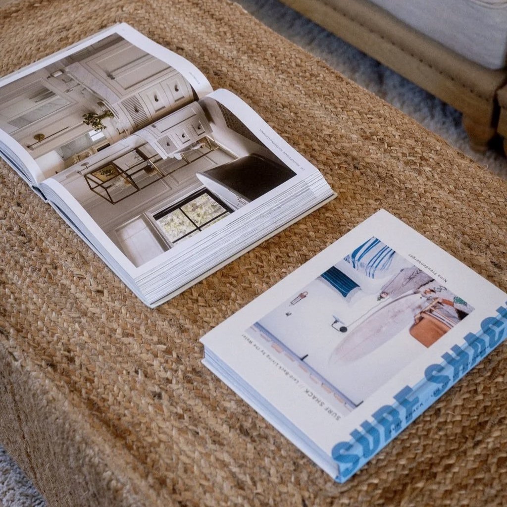 Lifestyle detail — magazine on woven table inside restored barn at Stargazey.