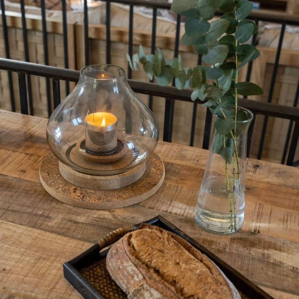 Rustic wooden table with candle and eucalyptus — cosy slow-living detail at Stargazey.