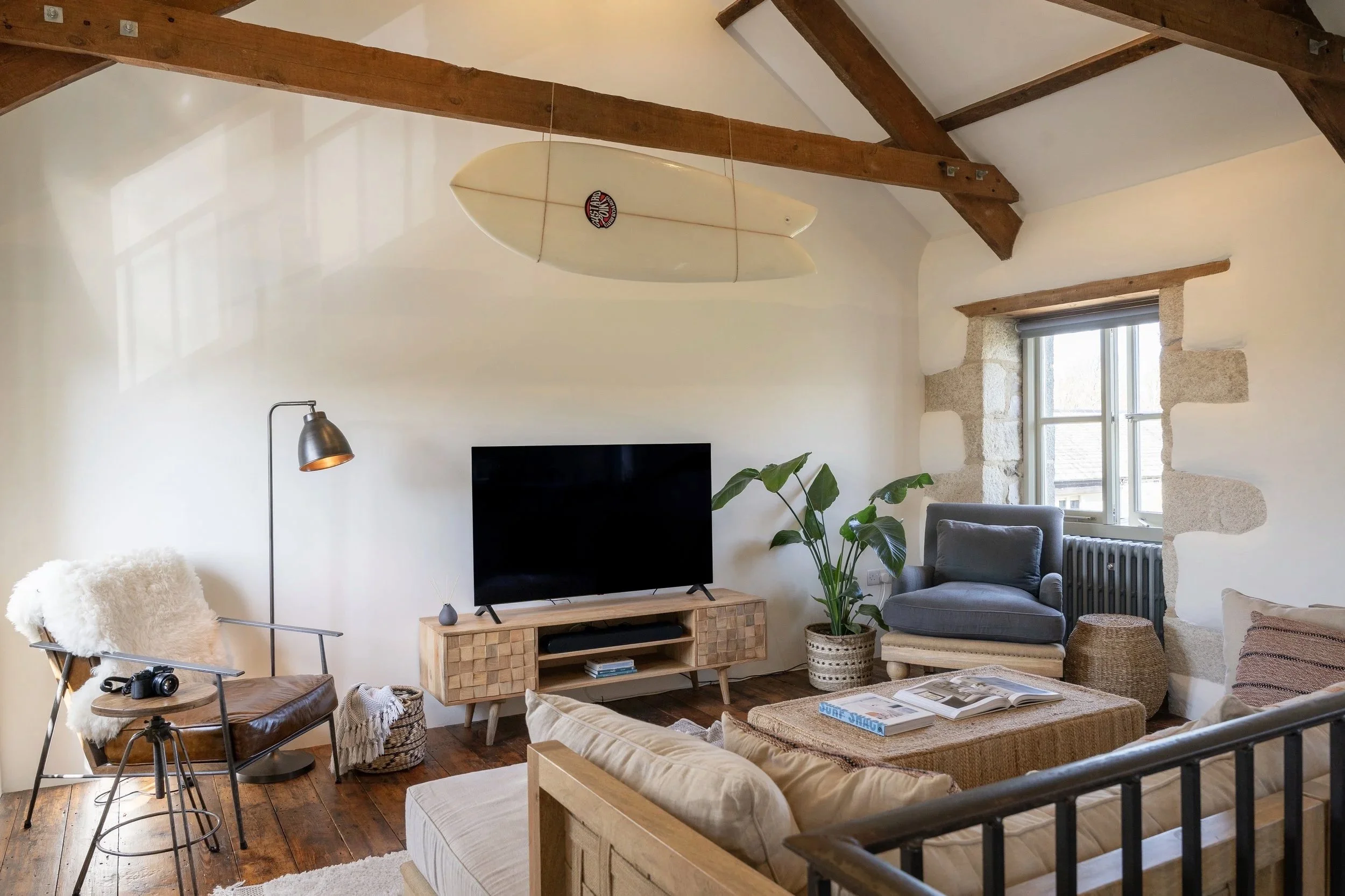 Living area at Stargazey with timber beams, natural textures and soft light in Cornwall.