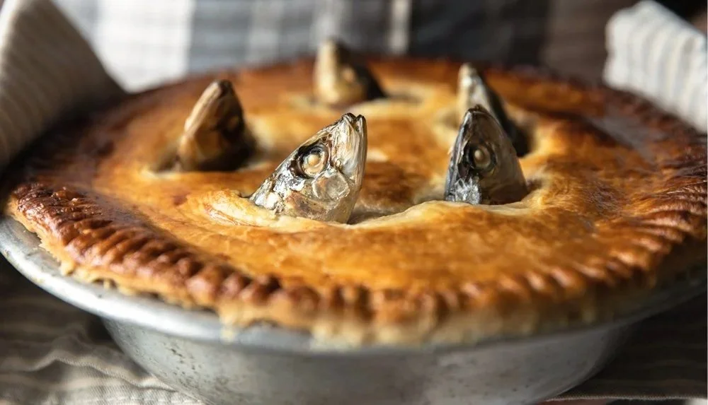 Stargazey pie served in the barn at Mawgan Porth, inspired by Cornish coastal tradition.