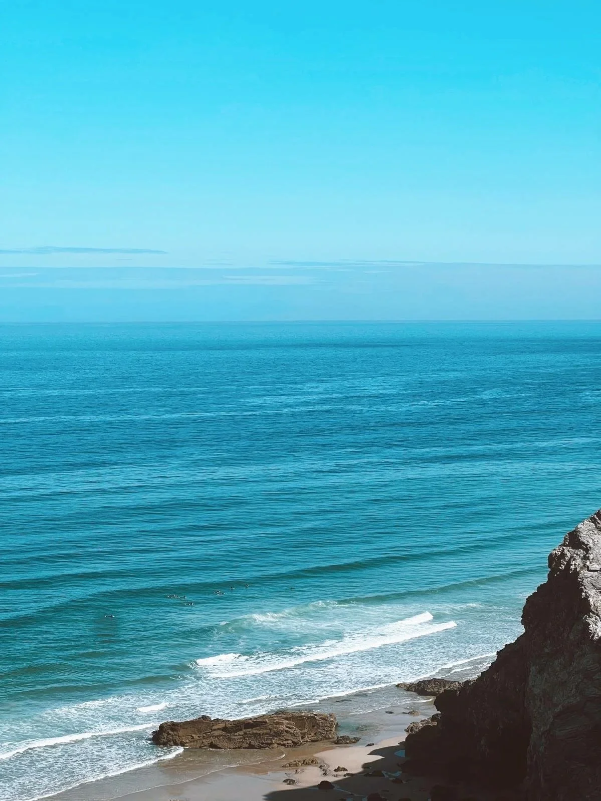 Surfing in North Cornwall, with gentle waves and soft coastal light.
