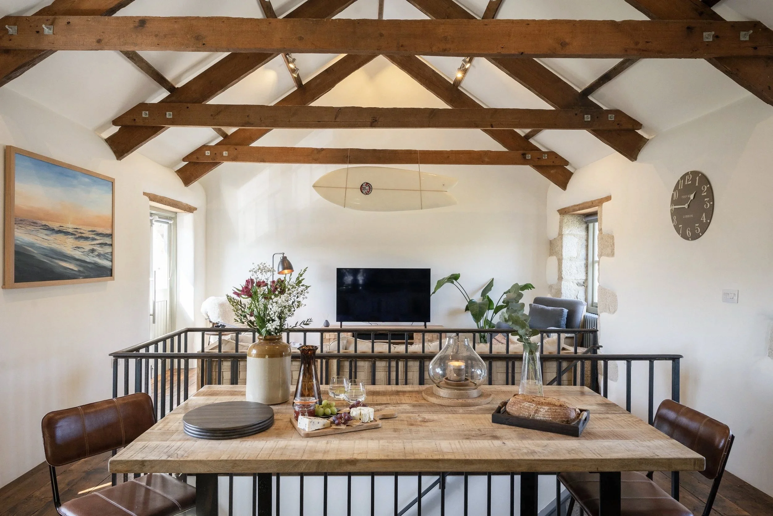 Living area at Stargazey with timber beams, natural textures and soft light in Cornwall.