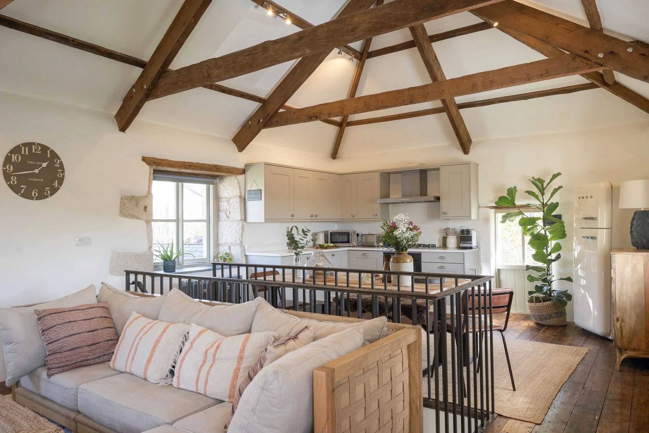 Living area at Stargazey with timber beams, natural textures and soft light in Cornwall.