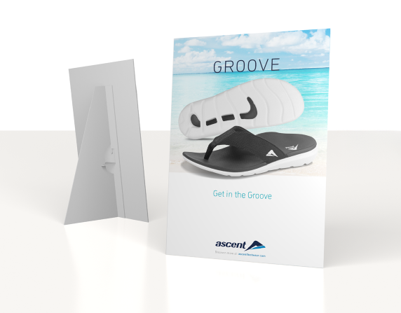 Posters advertising Groove sandals with beach background, one showing a white sandal and another displaying a black sandal, both with the Ascent logo.