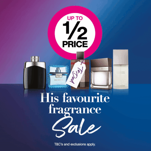 Display of men's and women's perfume bottles with a sign offering up to half price, promoting a fragrance sale.