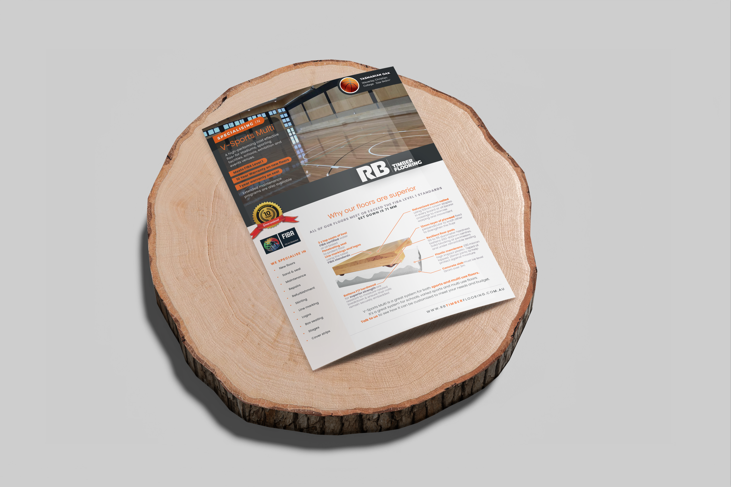 A flyer for RB Timber Flooring on a round wooden tree slice with visible rings, placed on a light gray background.