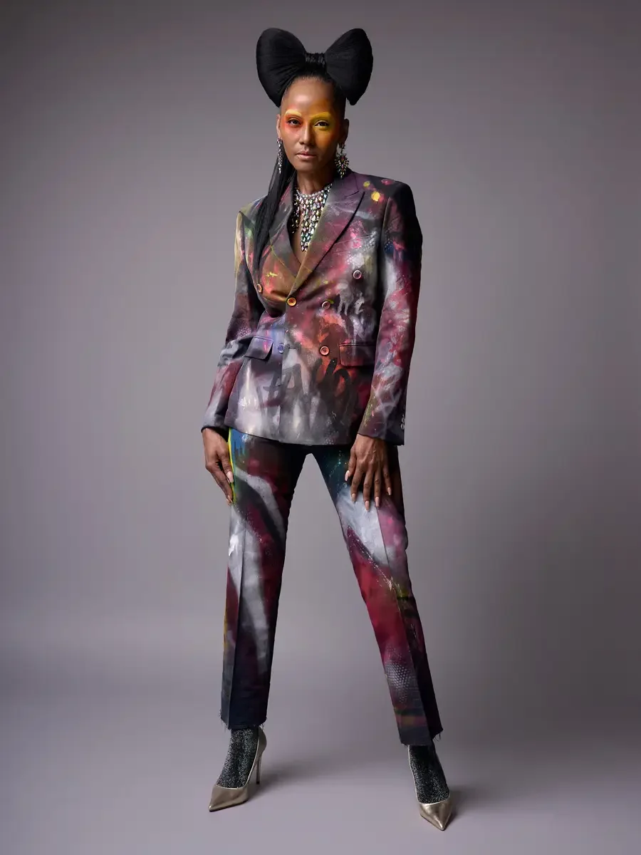 JUS10H Met Monday 2026, full-length hand-painted suit, front facing, iridescent necklace and chandelier earrings, grey background, photographed by Scott Parker Photo