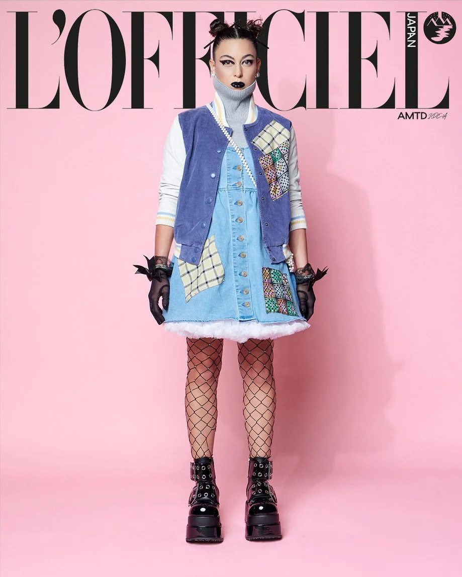 JUS10H Tokyo Remote Collection NYFW 2025 — model Vanessa in light blue denim button-front mini dress with plaid and multicolor mosaic embroidered patchwork panels, layered under a periwinkle blue varsity vest, white ribbed turtleneck, fishnet tights,