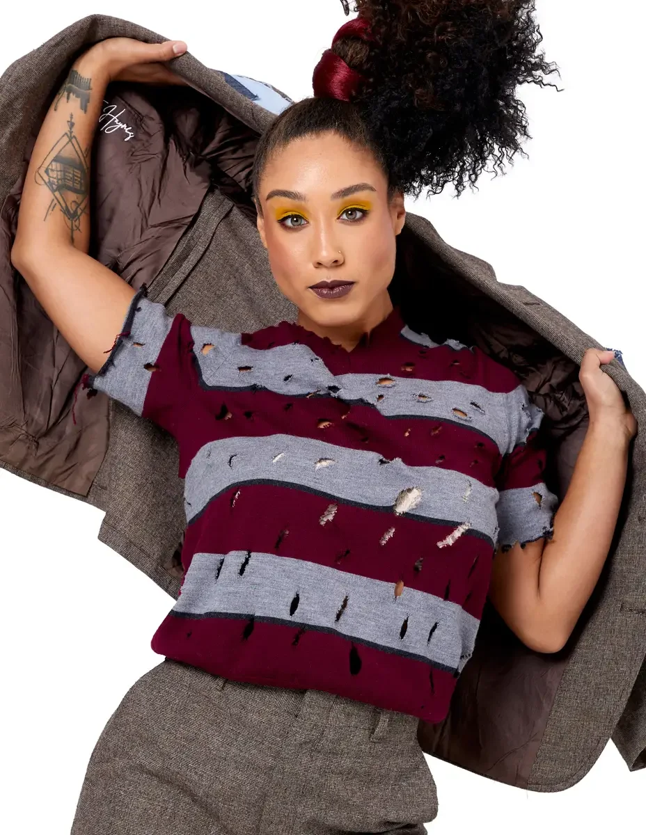 Model portfolio development session, high fashion editorial look, distressed burgundy and gray striped knit top, tweed blazer, bold yellow eyeshadow, dark lip, white background, photographed by Scott Parker Photo, New York