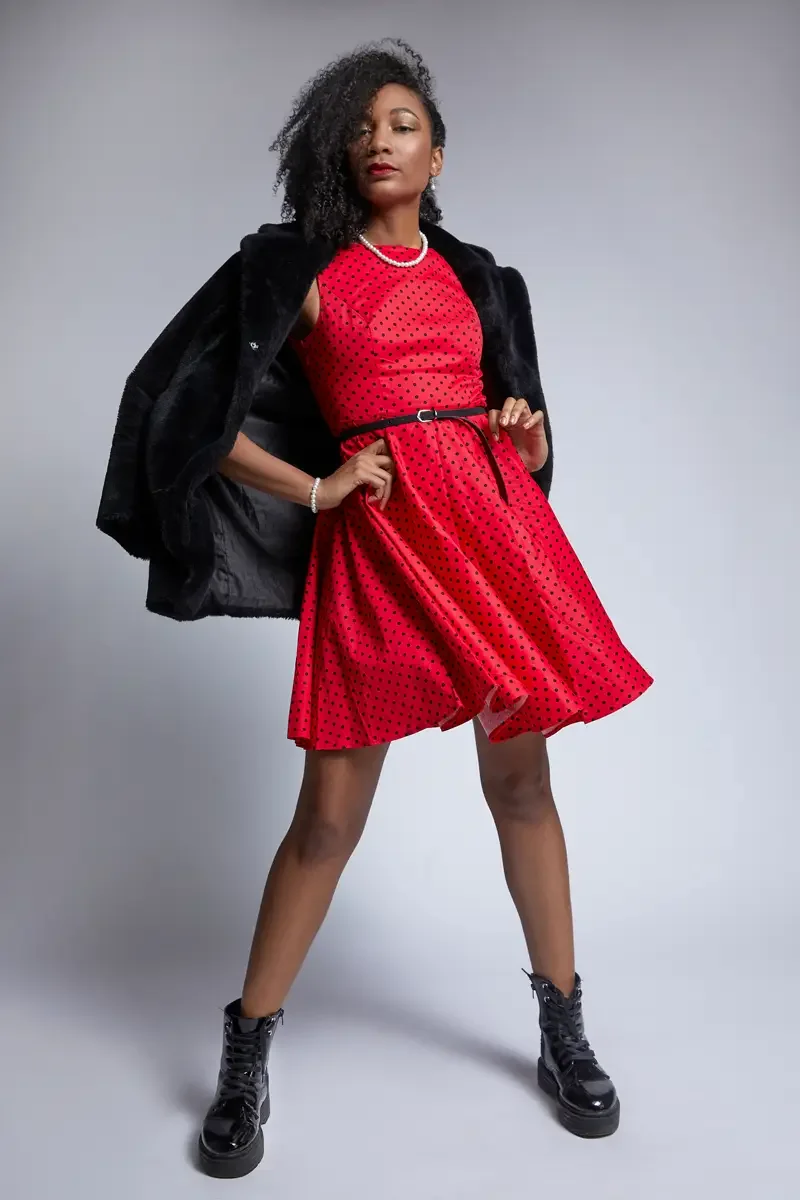 Arielle Chambers, seated on stool, red polka dot dress, pearl necklace, East Williamsburg studio test shoot, makeup by Schanica Pickens, photographed by Scott Parker Photo