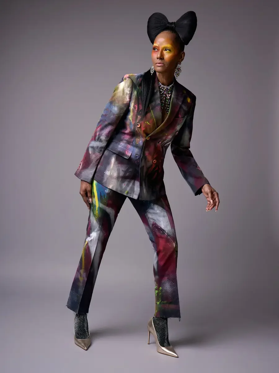 JUS10H Met Monday 2026, full-length hand-painted suit, three-quarter view in motion, grey background, photographed by Scott Parker Photo