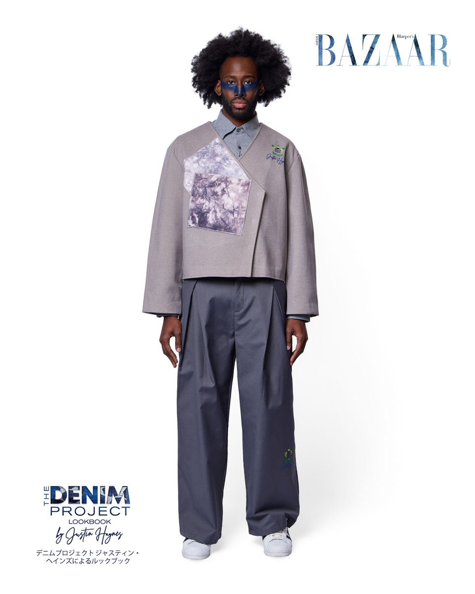 JUS10H Denim Project 2025 Harper's Bazaar Japan lookbook — male model in oversized grey wrap jacket with large tie-dye inset panel and JUS10H x Adidas Brazil emblem over wide-leg slate grey trousers, blue editorial makeup, fashion photography by Scot
