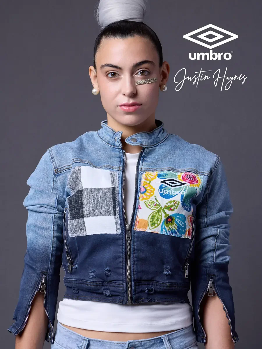 Editorial fashion photography for the Umbro France collection. Vanessa in a close crop portrait in a cropped two-tone denim moto jacket with floral patchwork panels, styled by Justin Haynes, model Vanessa directed by Scott Parker Photo for JUS10H wit