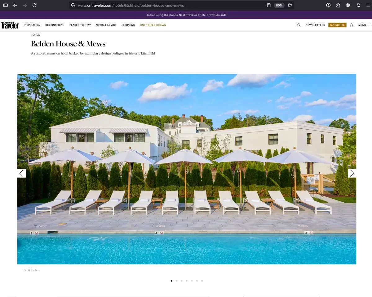 Belden House and Mews pool terrace, Litchfield Connecticut, lounge chairs and market umbrellas, photography by Scott Parker, featured in Conde Nast Traveler August 2025