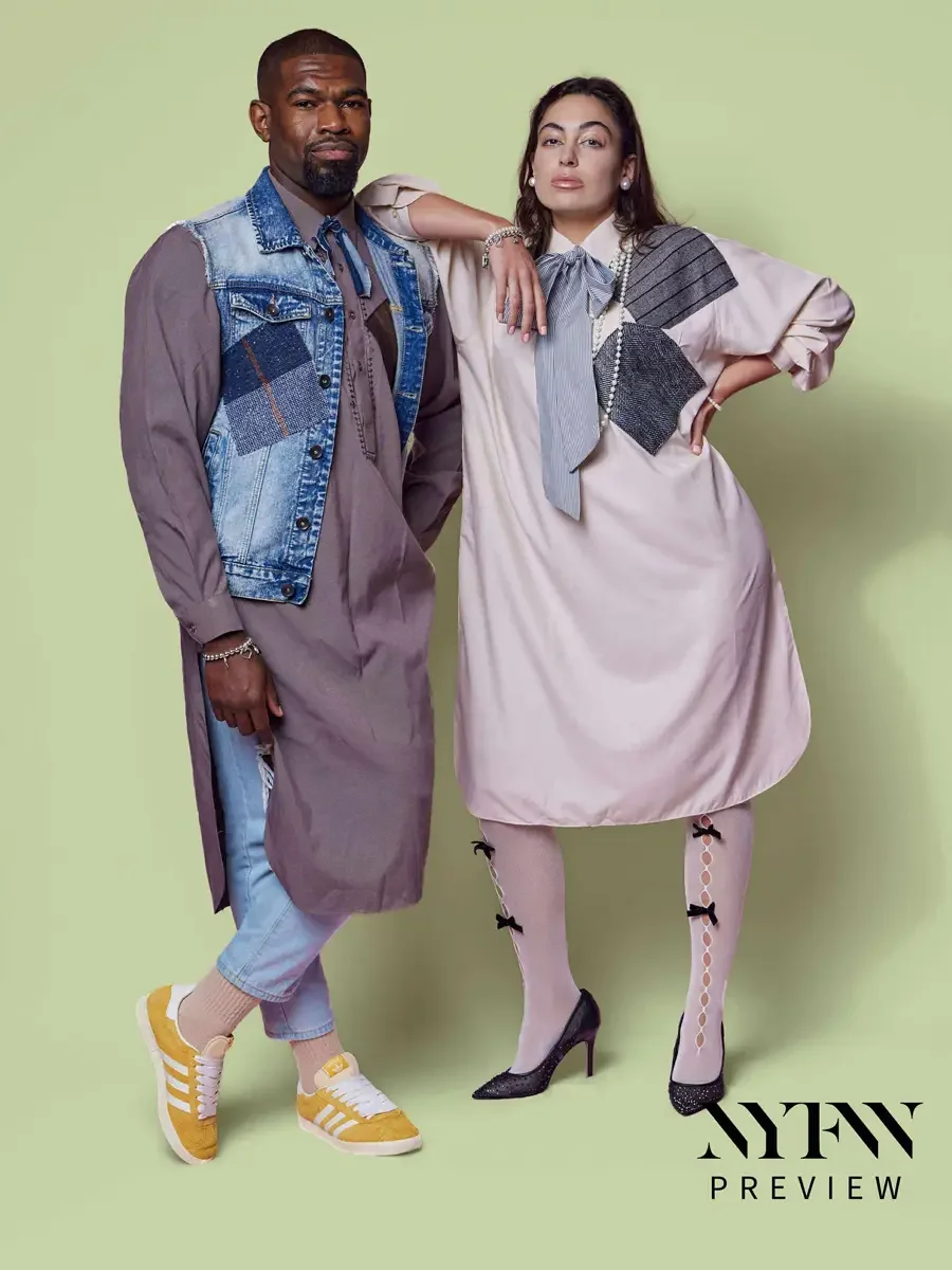 JUS10H 2025 print advertising, two models standing together, male in mauve longline shirt-dress with patchwork denim vest over light blue trousers and yellow sneakers, female in blush oversized shirt-dress with striped bow, metallic patchwork panel, 