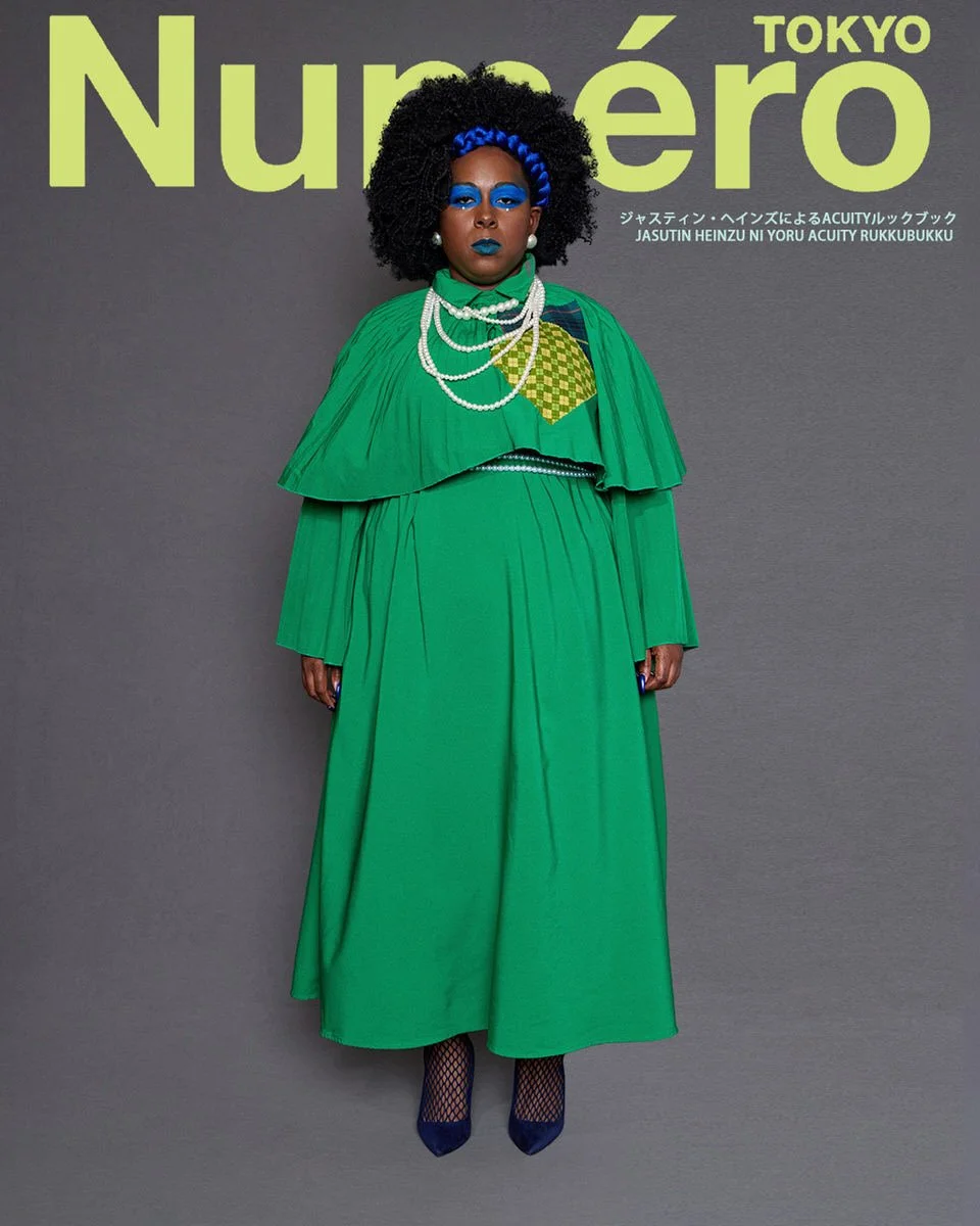 JUS10H by Justin Haynes ACUITY Collection lookbook for Numéro Tokyo by Scott Parker — model in emerald green pleated cape dress with checkered green and tartan patchwork chest panel, layered pearl necklaces, blue braided hair detail, and navy suede h